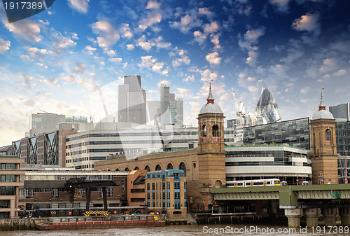 Image of City of London with clouds, financial center and Canary Wharf at