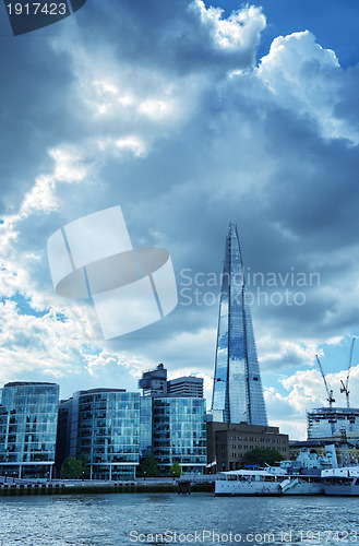 Image of London City Hall Skylines along River Thames against blue sky, E