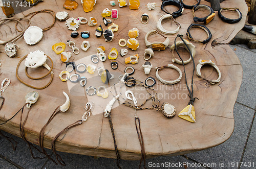 Image of handmade jewellery  bone amber on wooden table 