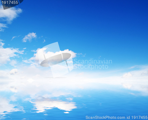 Image of white fluffy clouds with rainbow in the blue sky