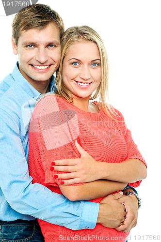 Image of Happy man embracing his wife from behind