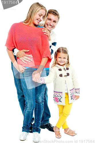 Image of Two young parents with pretty daughter