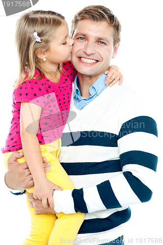 Image of Sweet daughter kissing her smiling father