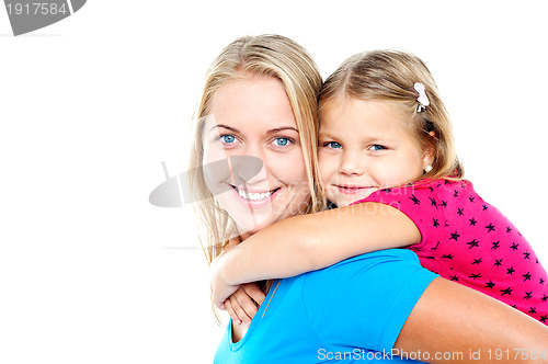 Image of Daughter enjoying piggy ride. Playful mother