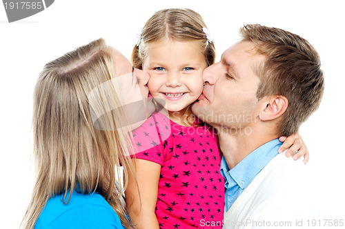 Image of Mom and dad kissing their beautiful kid