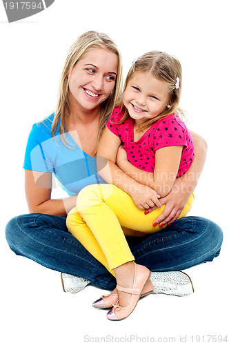 Image of Cute daughter sitting in mother's lap