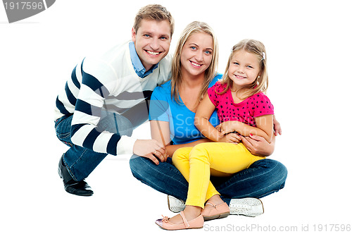 Image of Portrait of happy couple smiling with cute daughter