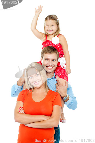 Image of Happy family of three members standing in embrace