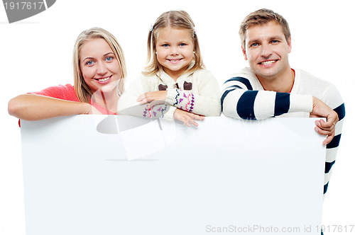 Image of Smiling family with whiteboard in a studio