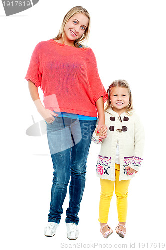 Image of Mum and daughter posing in trendy outfits