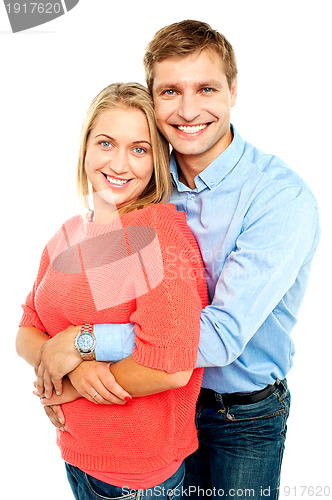 Image of Husband embracing his gorgeous wife from behind