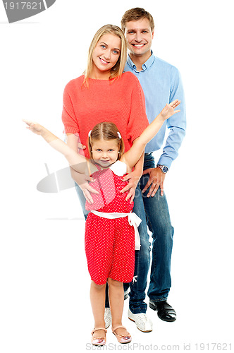 Image of Cheerful family of three posing indoors