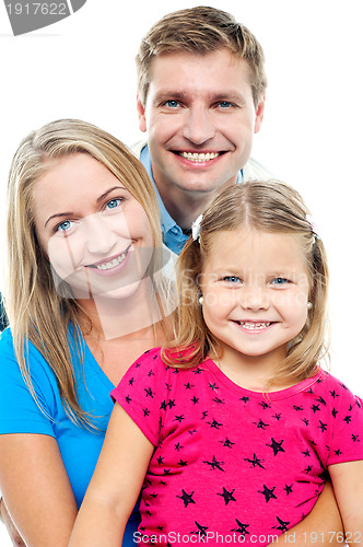 Image of Parents posing with cute smiling daughter