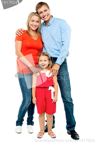 Image of Mother, father and cute daughter posing in trendy outfits