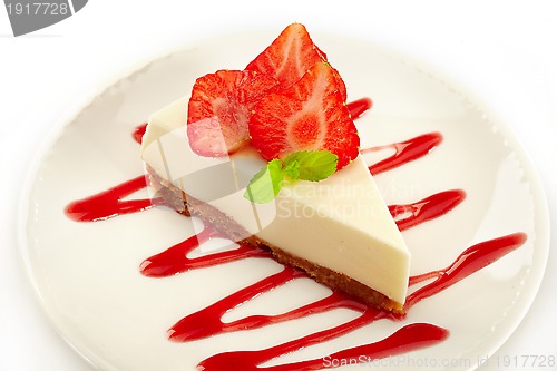Image of cheesecake with strawberries on white plate