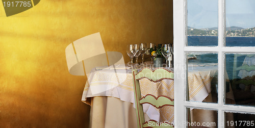 Image of Arranged table in a restaurant and open window