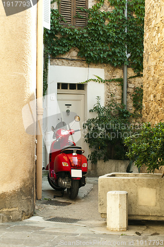 Image of Small scooter parked at the old quarter buildings