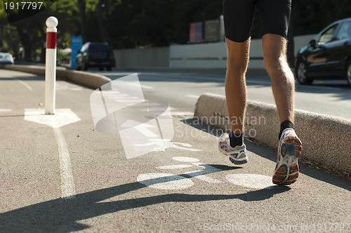 Image of Human feets in sportshoes running 