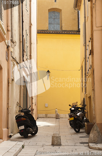 Image of Scooters parked at the old buildings.