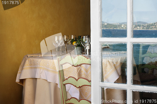 Image of Arranged table in a restaurant and open window