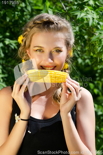 Image of woman eating corn-cob