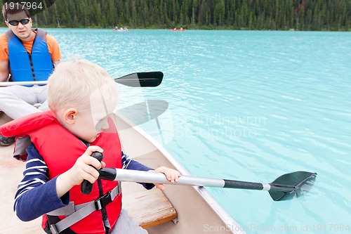 Image of father and son on a lake