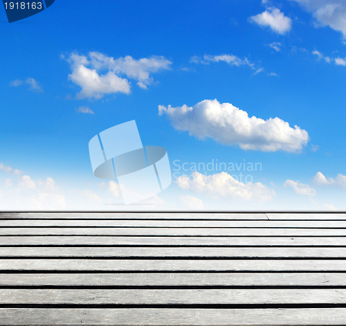 Image of blue sky and wood floor background