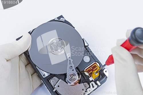 Image of technician with open hard-disk