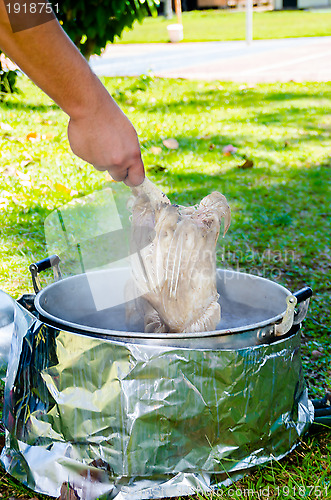 Image of chicken soaked in hot water