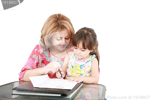 Image of Mother and daughter doing homework at home 