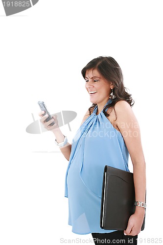 Image of a pregnant woman texting on her cell phone with a happy expressi