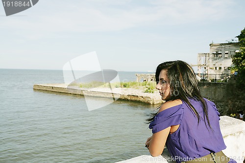 Image of Beautiful caucasian woman looking out over sea 