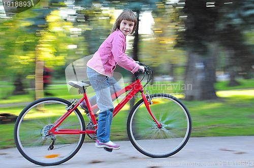 Image of child riding  bike in park
