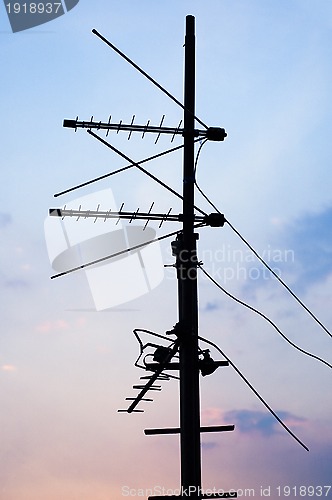 Image of silhouette of television antennas on the roof...