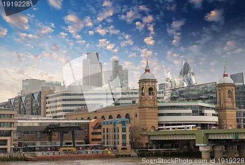 Image of City of London with clouds, financial center and Canary Wharf at