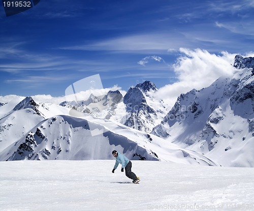 Image of Young snowboarder on ski slope