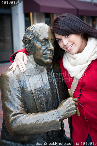 Image of Woman Posing with Public Statue