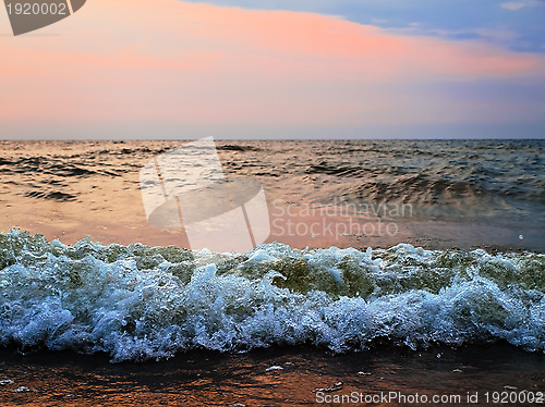 Image of sunset at stormy sea