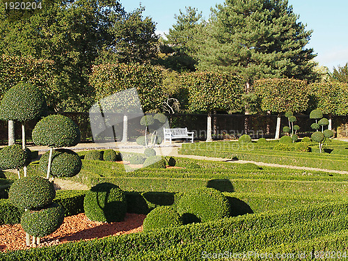 Image of bench in a french garden in fall, anjou, France.