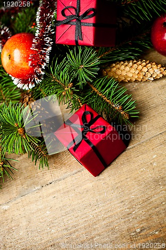 Image of fir tree with pinecones, decorations and apples 