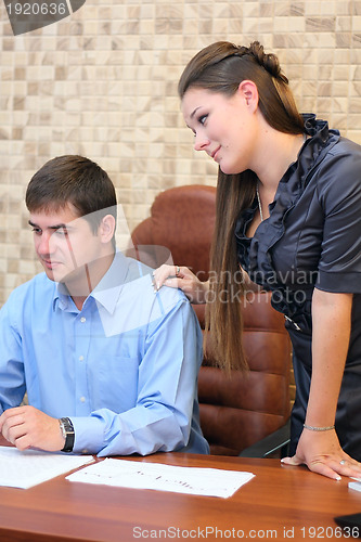 Image of Girl and man working in the office