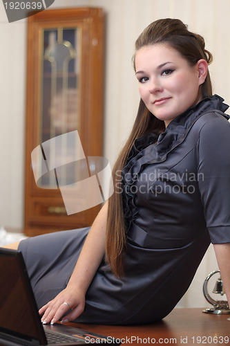 Image of Girl sitting on the desk