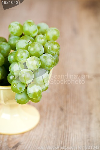 Image of fresh green grapes in a yellow bowl 