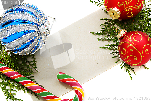 Image of Christmas balls, candy and cards.