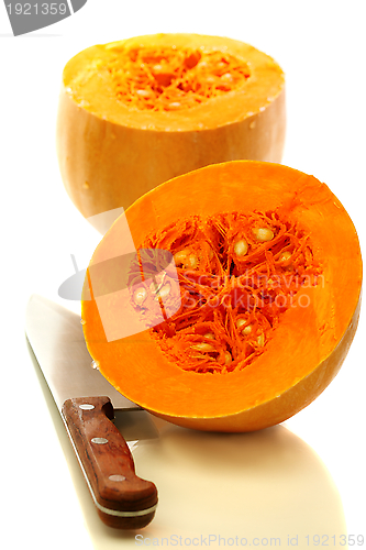 Image of Ripe pumpkin and knife.