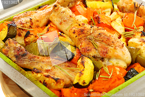 Image of Chicken baked with pumpkin and rosemary.