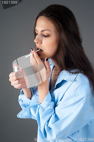 Image of beautiful young brunette woman with cigarette