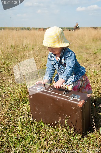 Image of lonely girl with suitcase