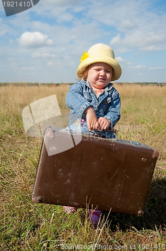 Image of lonely girl with suitcase