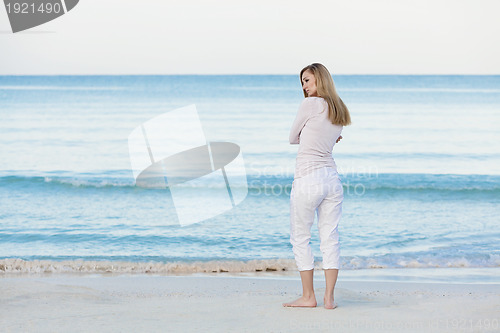 Image of beautiful blonde woman alone at the beach